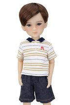 Doll wearing a striped shirt and shorts on a white background