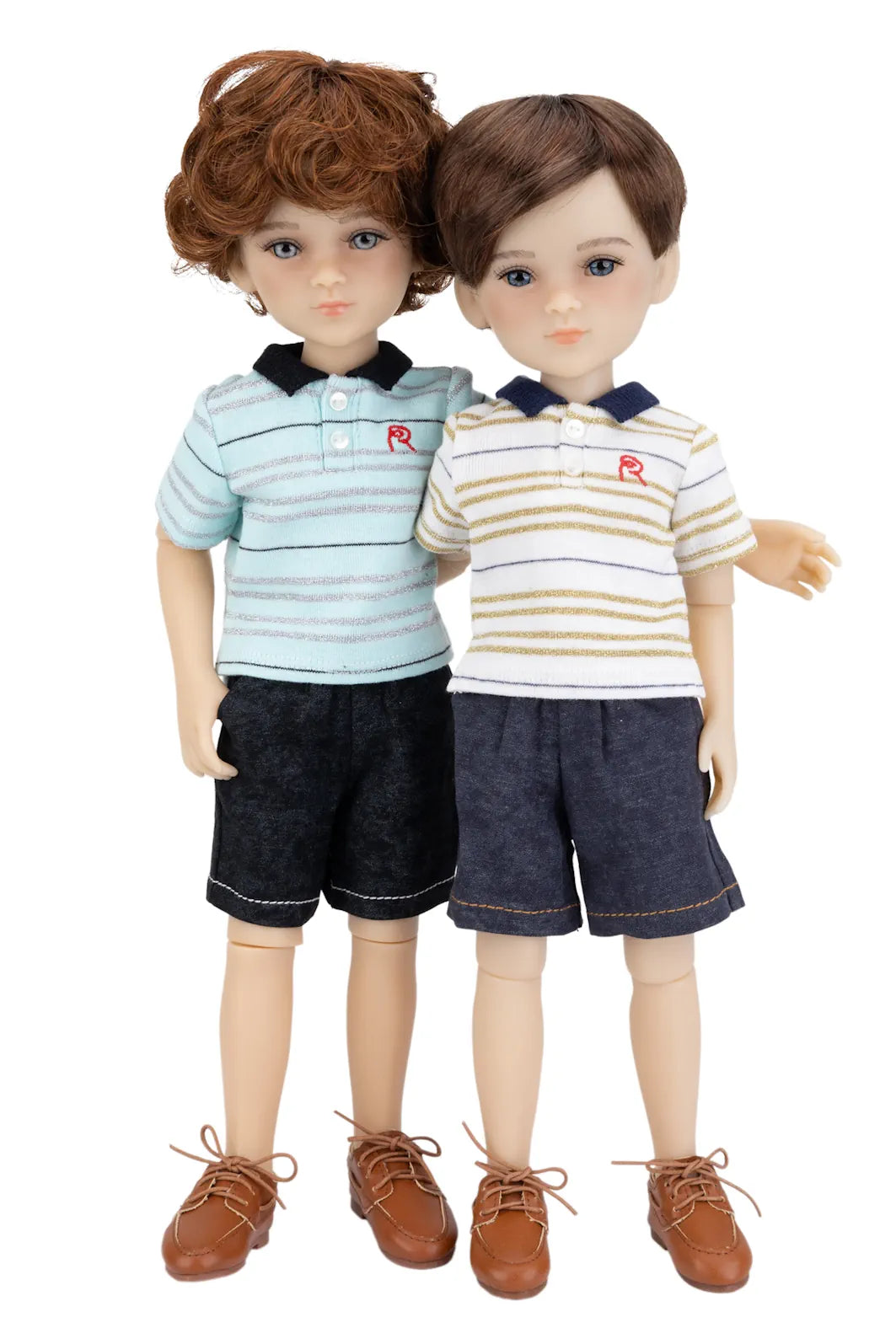 Two dolls wearing matching outfits with striped shirts and shorts on a white background