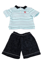 Doll's outfit with striped shirt and black shorts on a white background