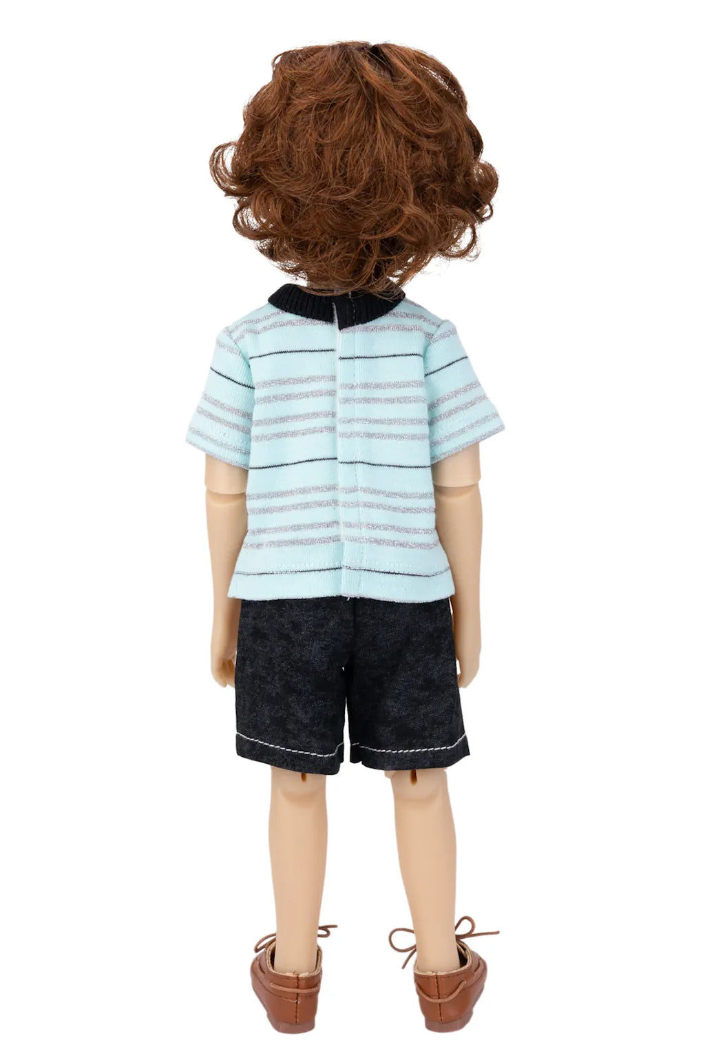 Doll wearing a striped shirt and shorts on a white background