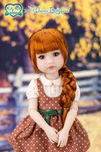Doll with red hair and a brown dress with white polka dots, set against a outdoor background.