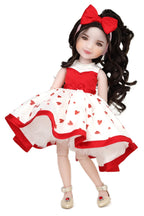 Doll wearing a red and white dress with heart patterns on a white background