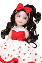 Doll with long dark hair and a red bow, wearing a white dress with red hearts.