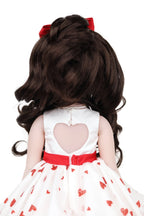 Doll with long dark hair and a white dress with red hearts on a white background