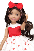 Doll with red bow, red and white dress with heart pattern on a white background