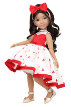 Doll wearing a red and white dress with heart patterns on a white background