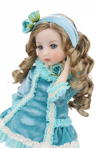 Doll in a blue dress with floral accessories on a white background