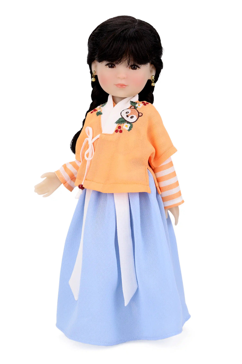 Doll wearing an orange top and light blue skirt on a white background