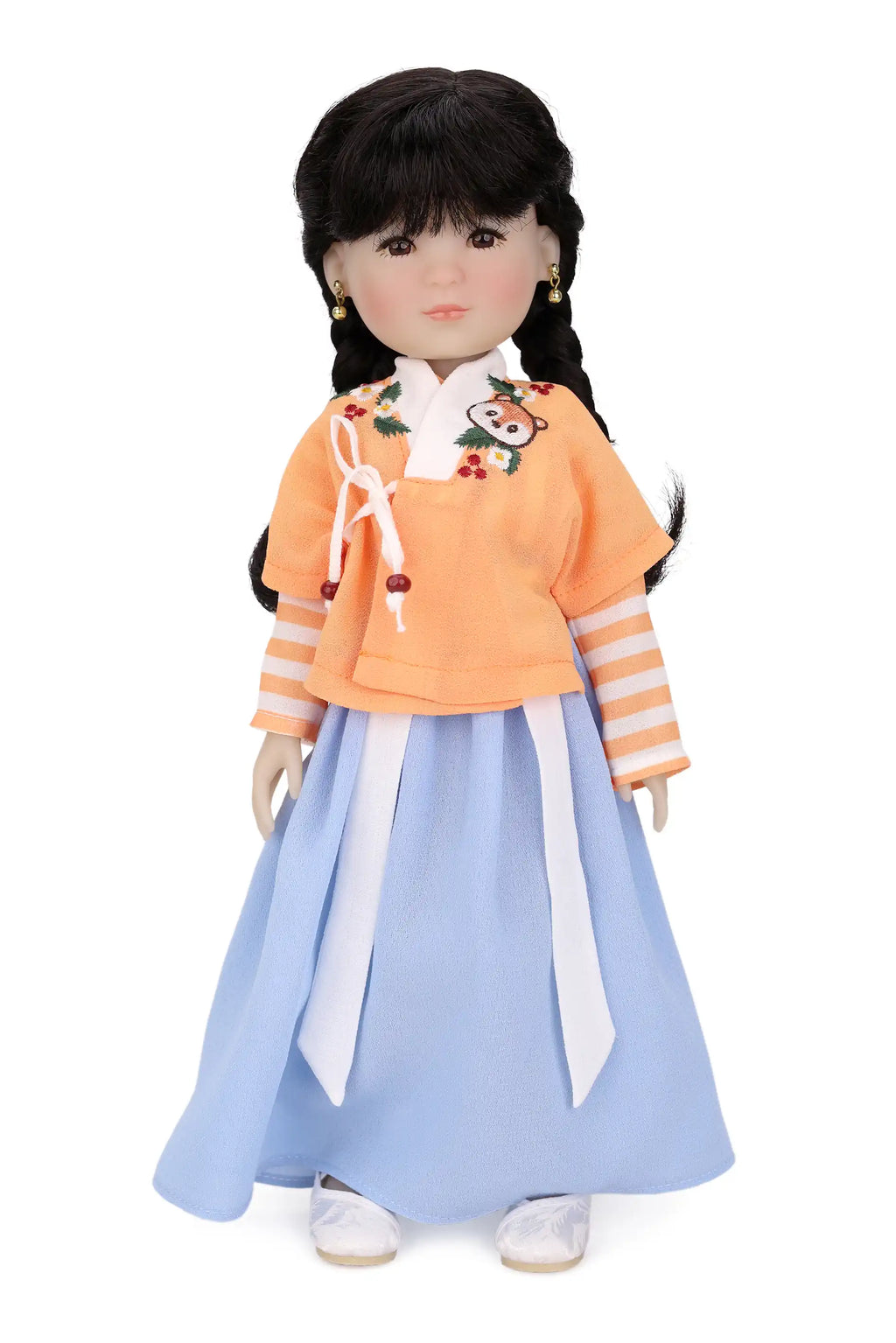 Doll wearing a traditional outfit with an orange top and blue skirt on a white background