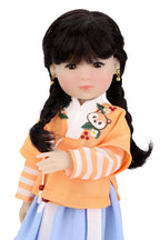 Doll wearing a traditional outfit with an orange top and blue skirt on a white background