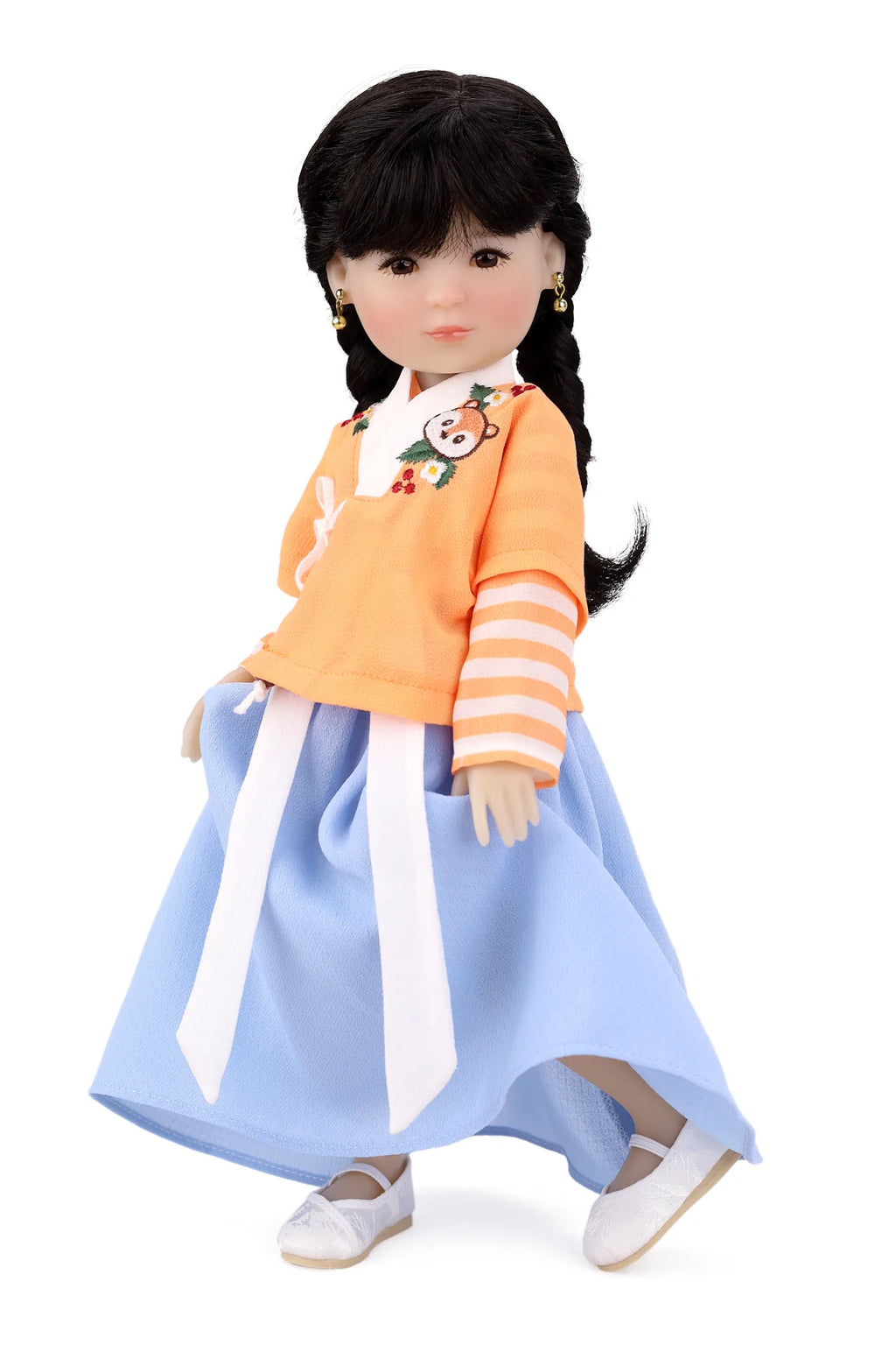 Doll wearing a traditional outfit with an orange top and blue skirt on a white background
