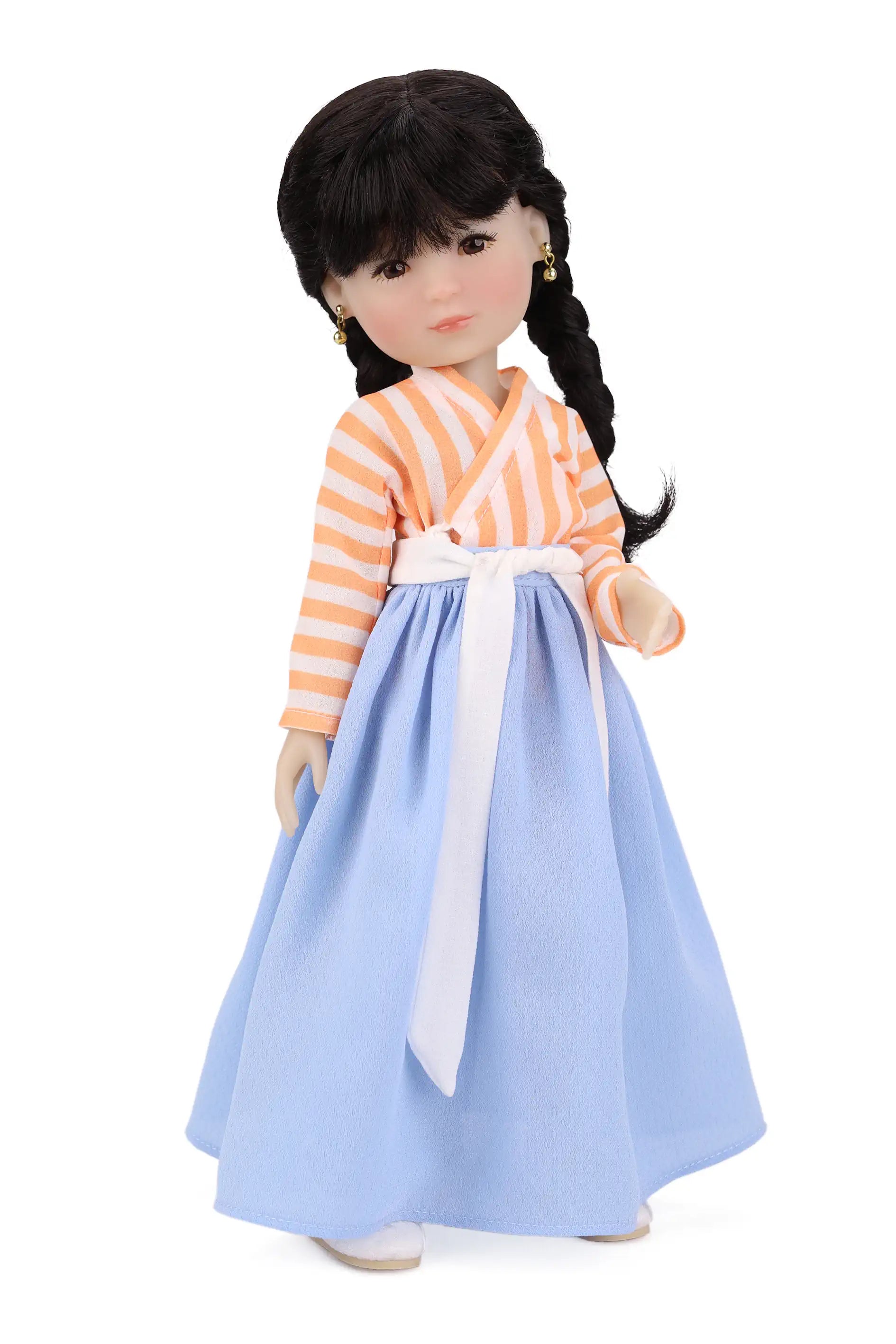 Doll wearing a traditional outfit with an orange and white striped top with a blue skirt on a white background