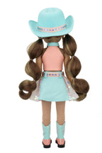 Amina with long brown hair styled in pigtails, wearing a turquoise cowboy hat, pink top, light blue skirt, and turquoise boots on a white background.