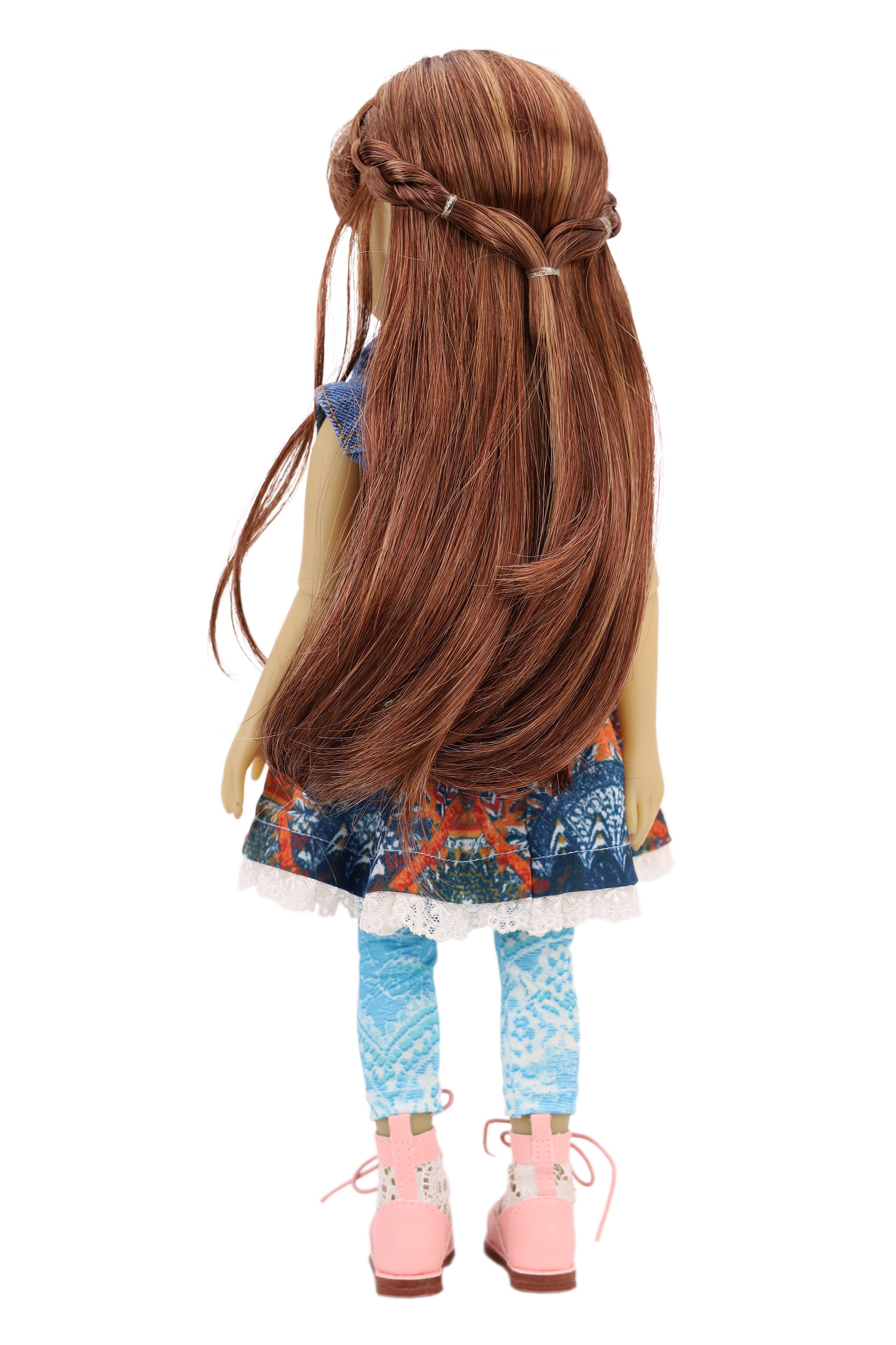 Bella wearing a denim jacket, colorful skirt, and pink shoes on a white background