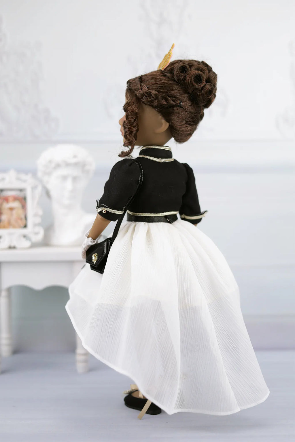 Esther in a black and white outfit with a white background
