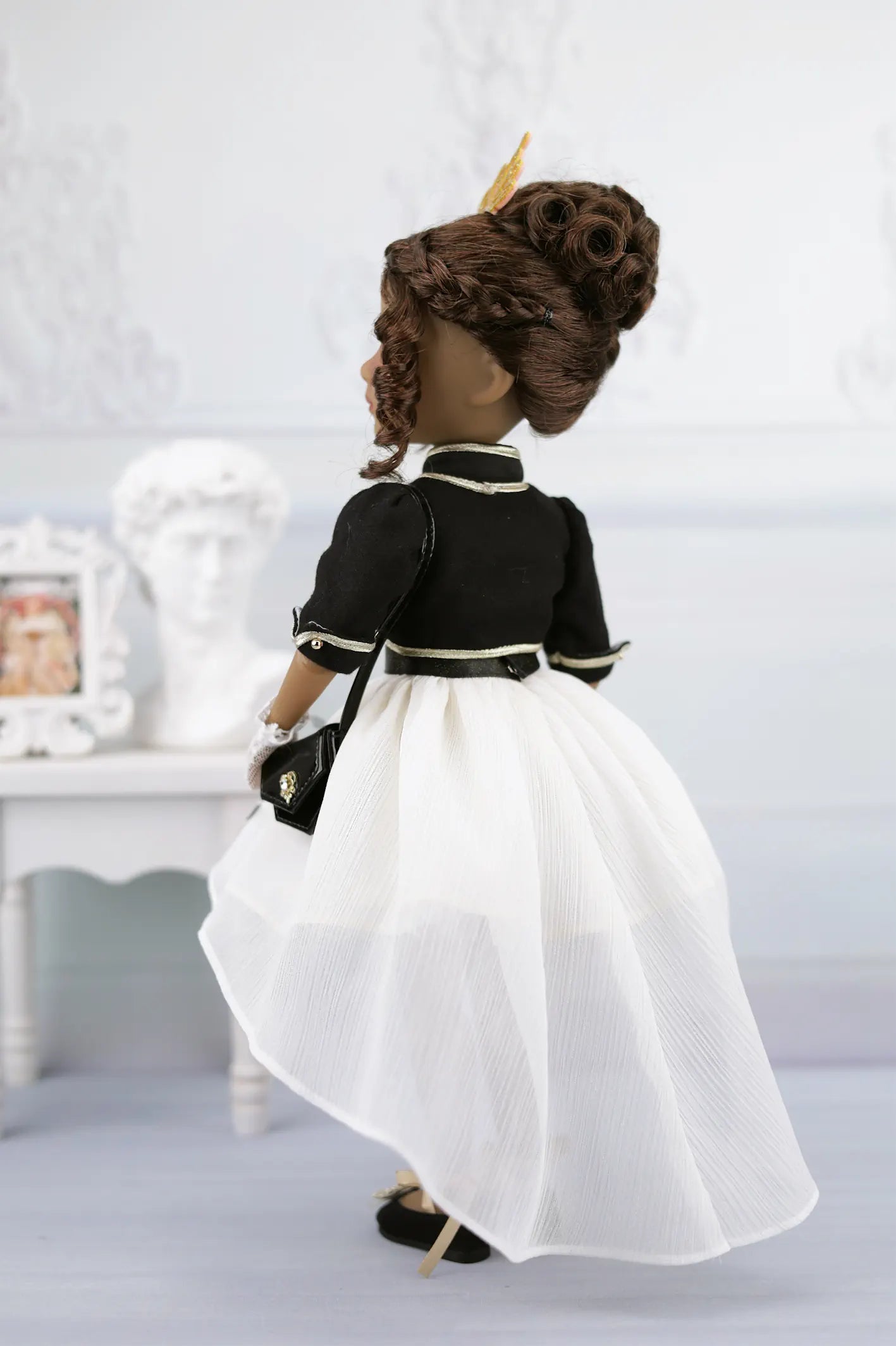 Esther in a black and white outfit with a white background