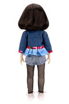 Hanna wearing a denim outfit with a white background