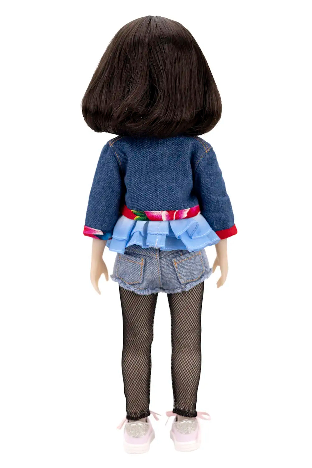 Doll wearing a denim outfit with a colorful belt on a white background