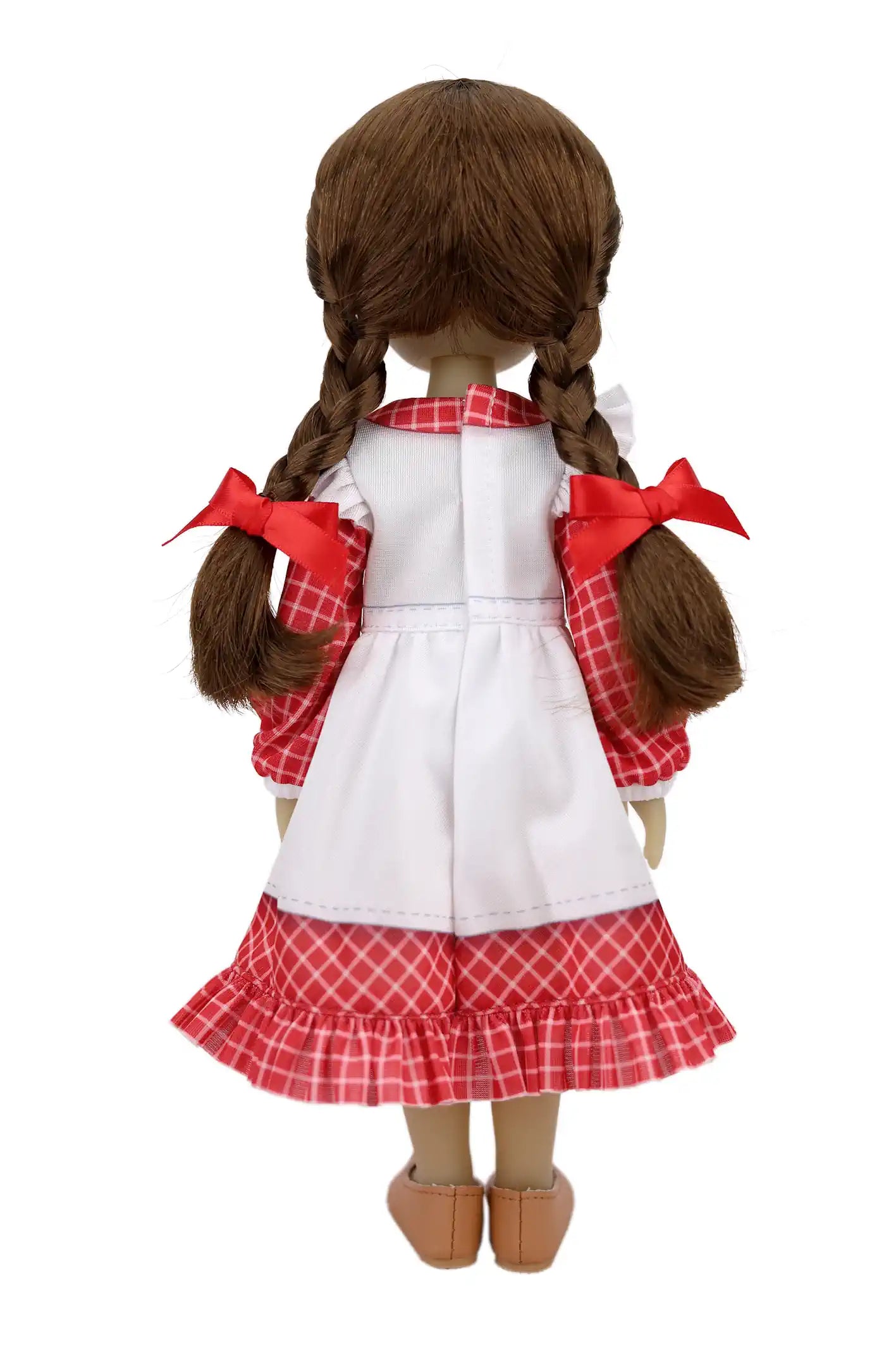 From behind, Jeannette shows her brown braids with red bows, a checkered dress under a white apron, and brown shoes.