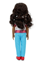 Mila, a doll with long curly brown hair, stands with her back to the viewer, wearing a white blouse with checkered trim, light blue pants, and red shoes, against a white background.