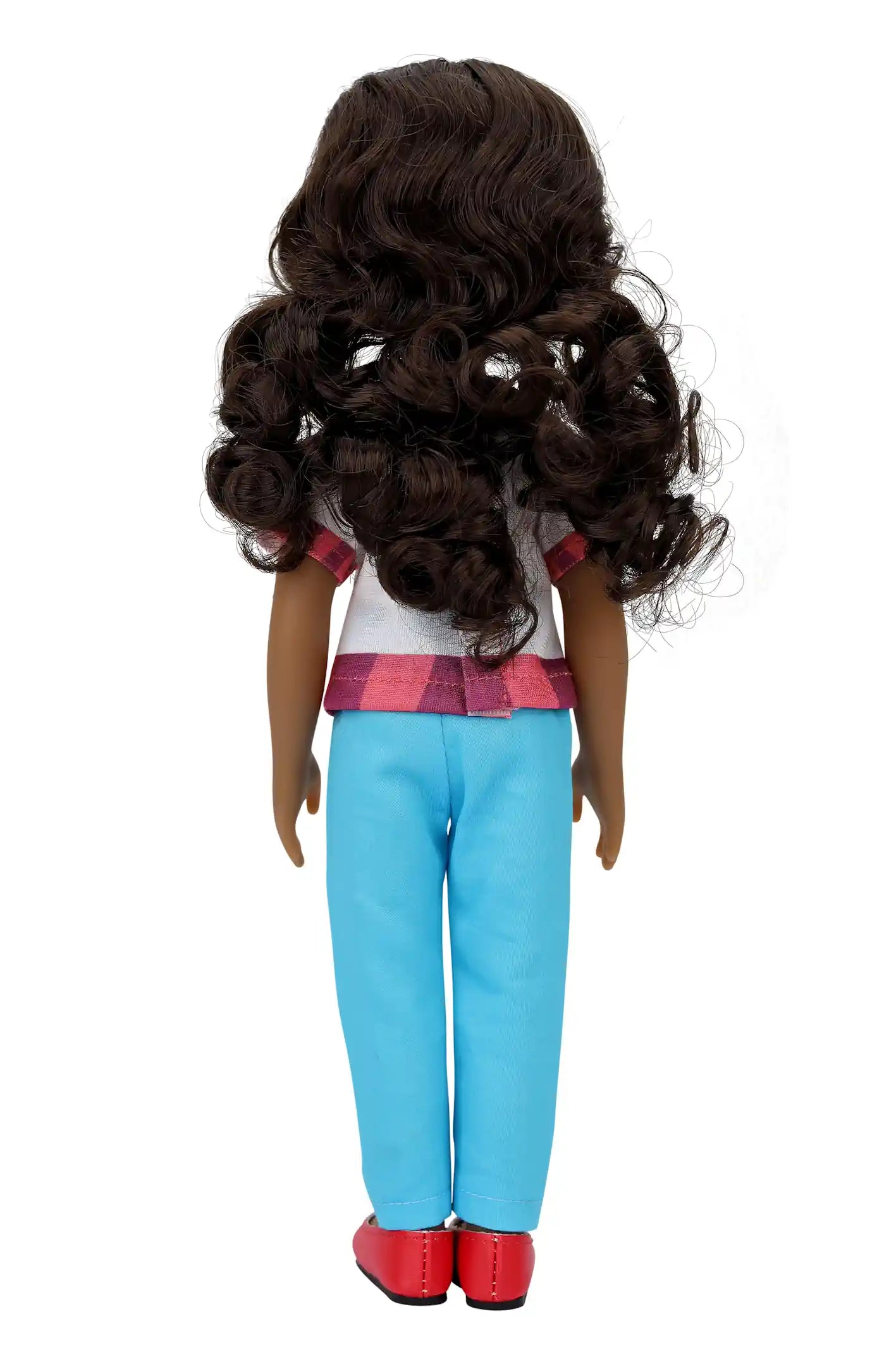 Mila, a doll with long curly brown hair, stands with her back to the viewer, wearing a white blouse with checkered trim, light blue pants, and red shoes, against a white background.