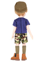 Rory wearing a blue shirt, camouflage shorts, and brown boots on a white background