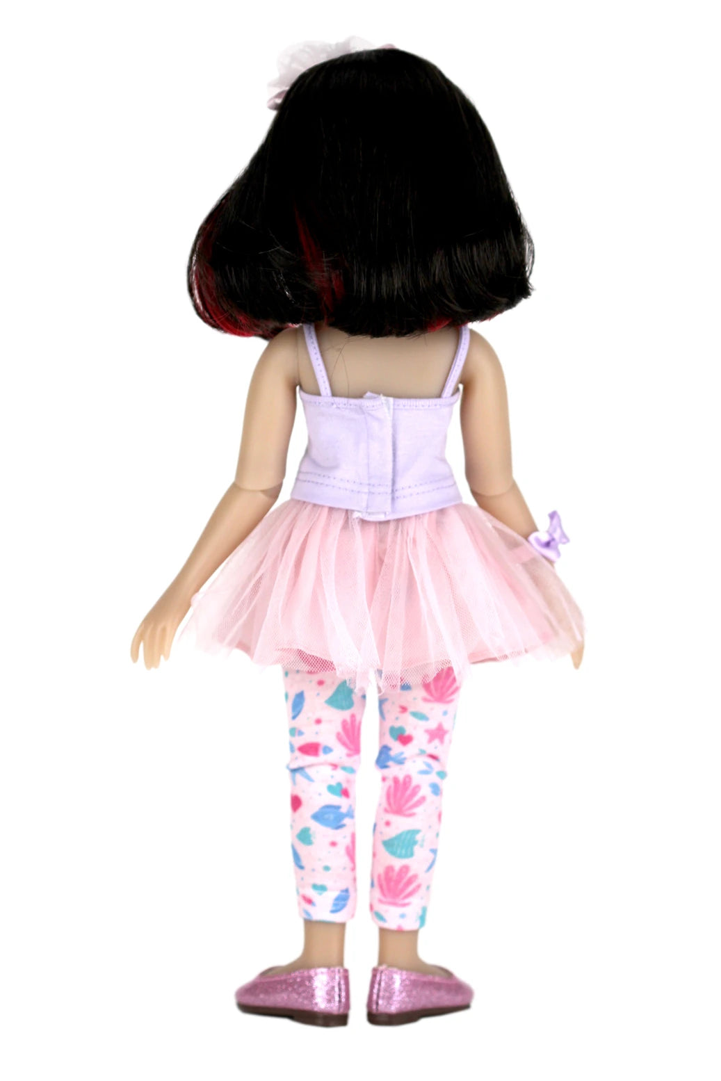 Sydney wearing a pink outfit with a tutu and shell-patterned leggings on a white background