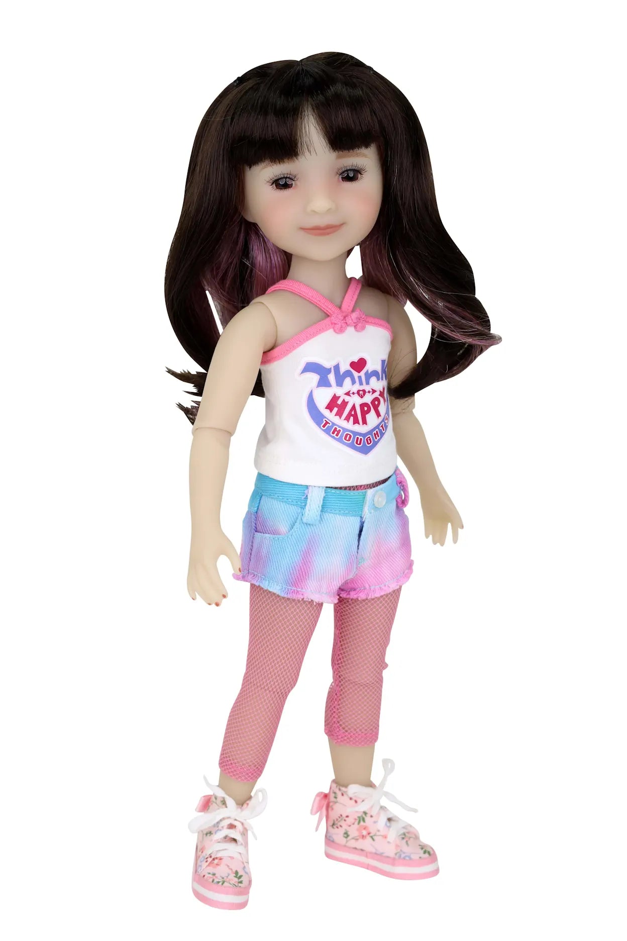 Hanna doll with long brown hair wearing white 'Think Happy Thoughts' tank, tie-dye shorts, fishnet tights, and floral sneakers.