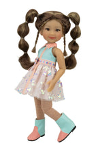 Abby with pigtails wearing a light blue dress with floral patterns and matching boots on a white background