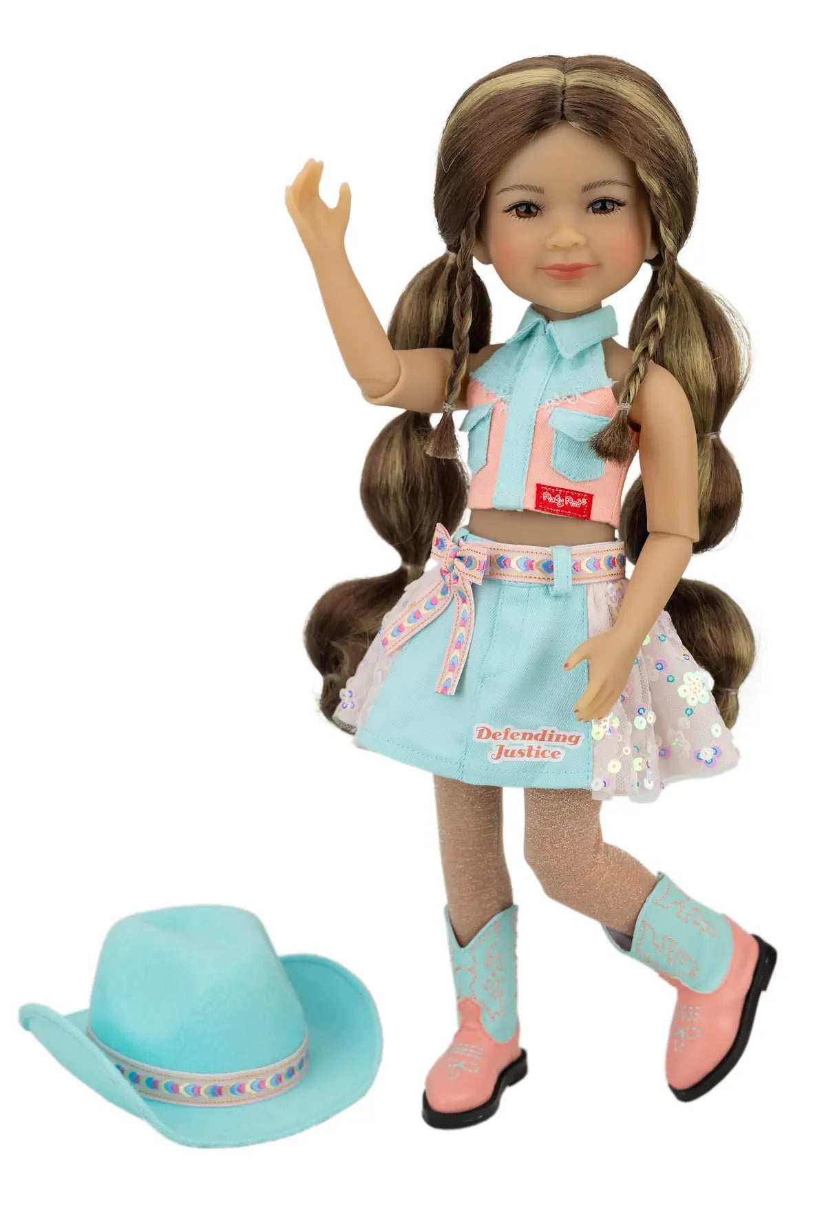 Amina in a turquoise outfit with a matching hat on a white background