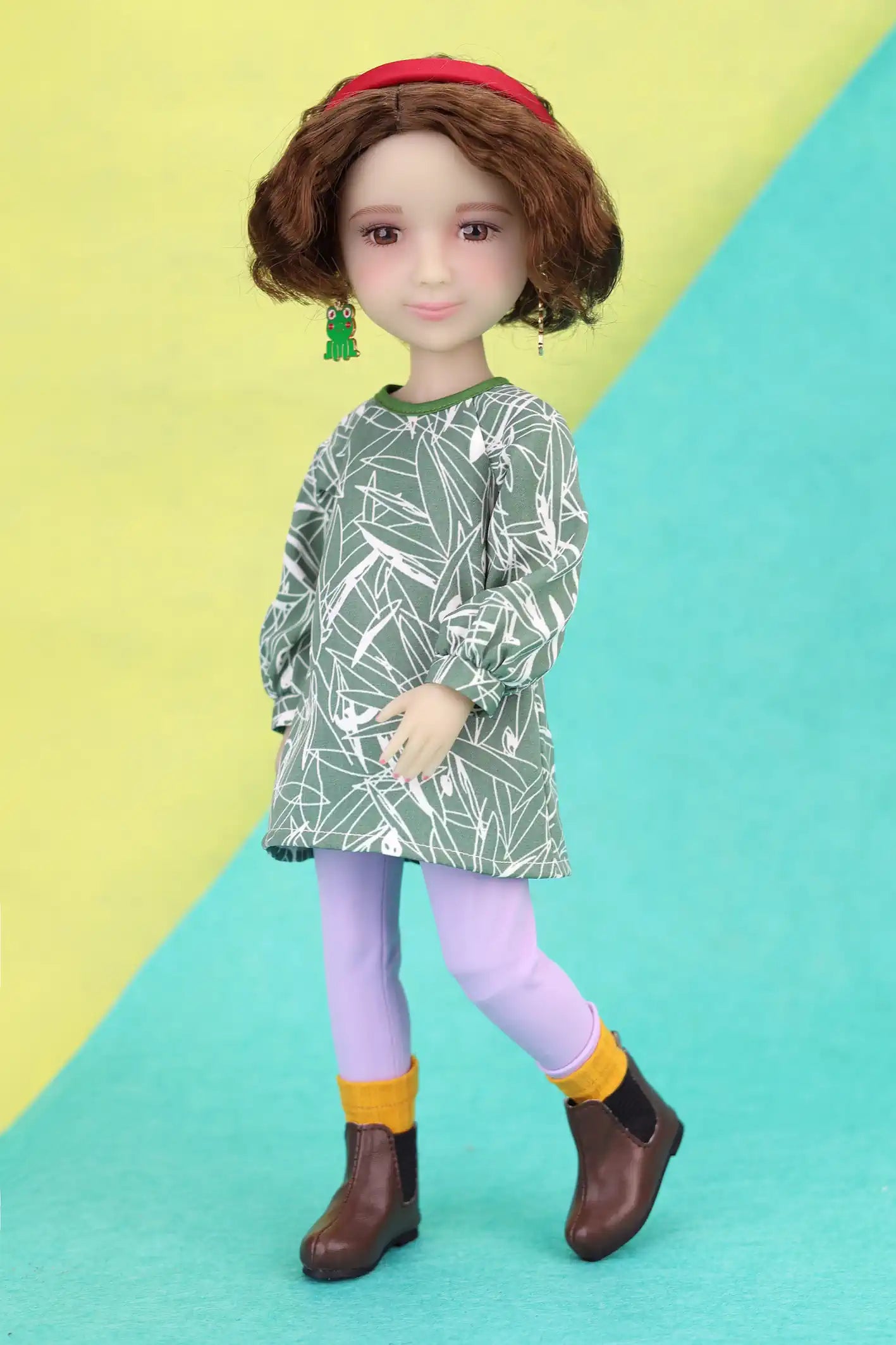 Ava wearing a green leaf-patterned dress on a colorful background