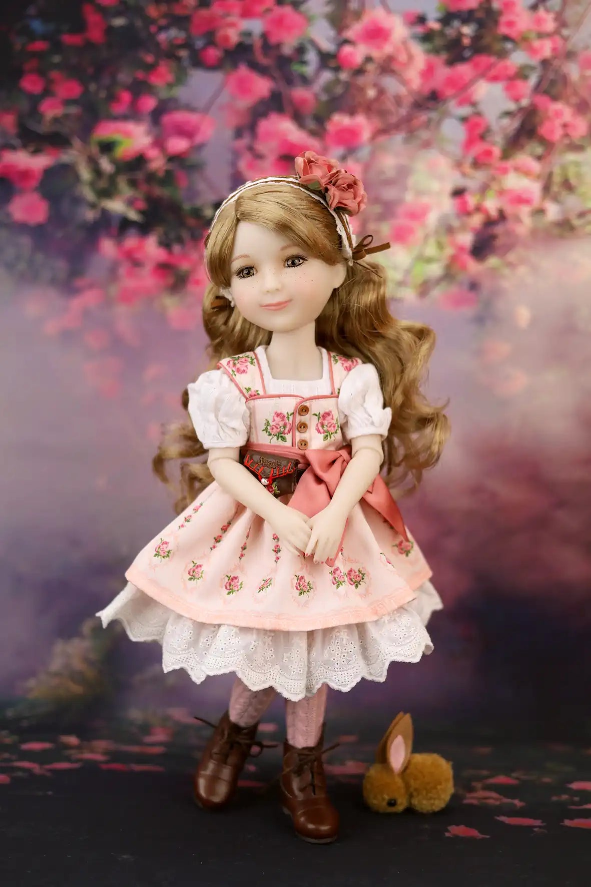 Eden in a floral dress with a cherry blossom background
