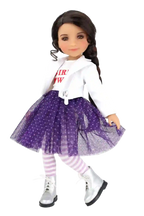 Freida wearing a white shirt with text, purple skirt, and striped leggings on a white background