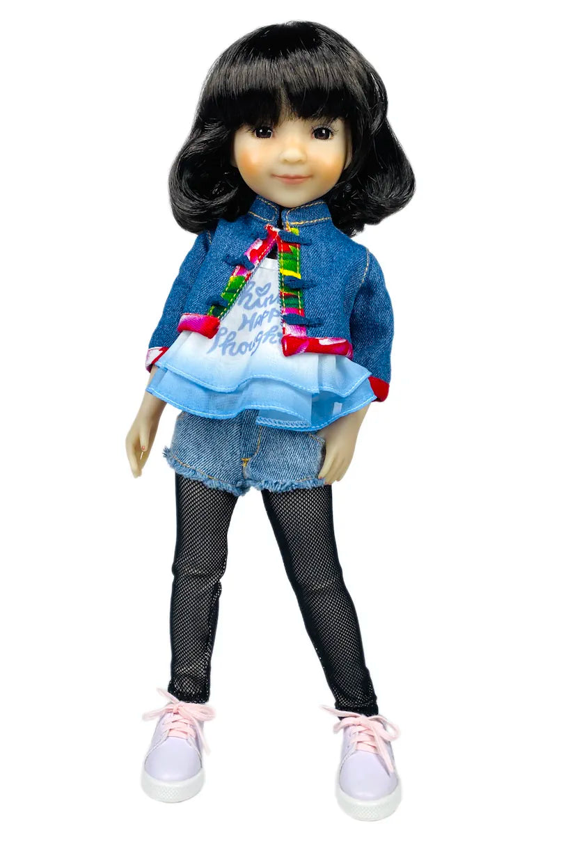 Hanna wearing a denim jacket, colorful shirt, and black pants on a white background