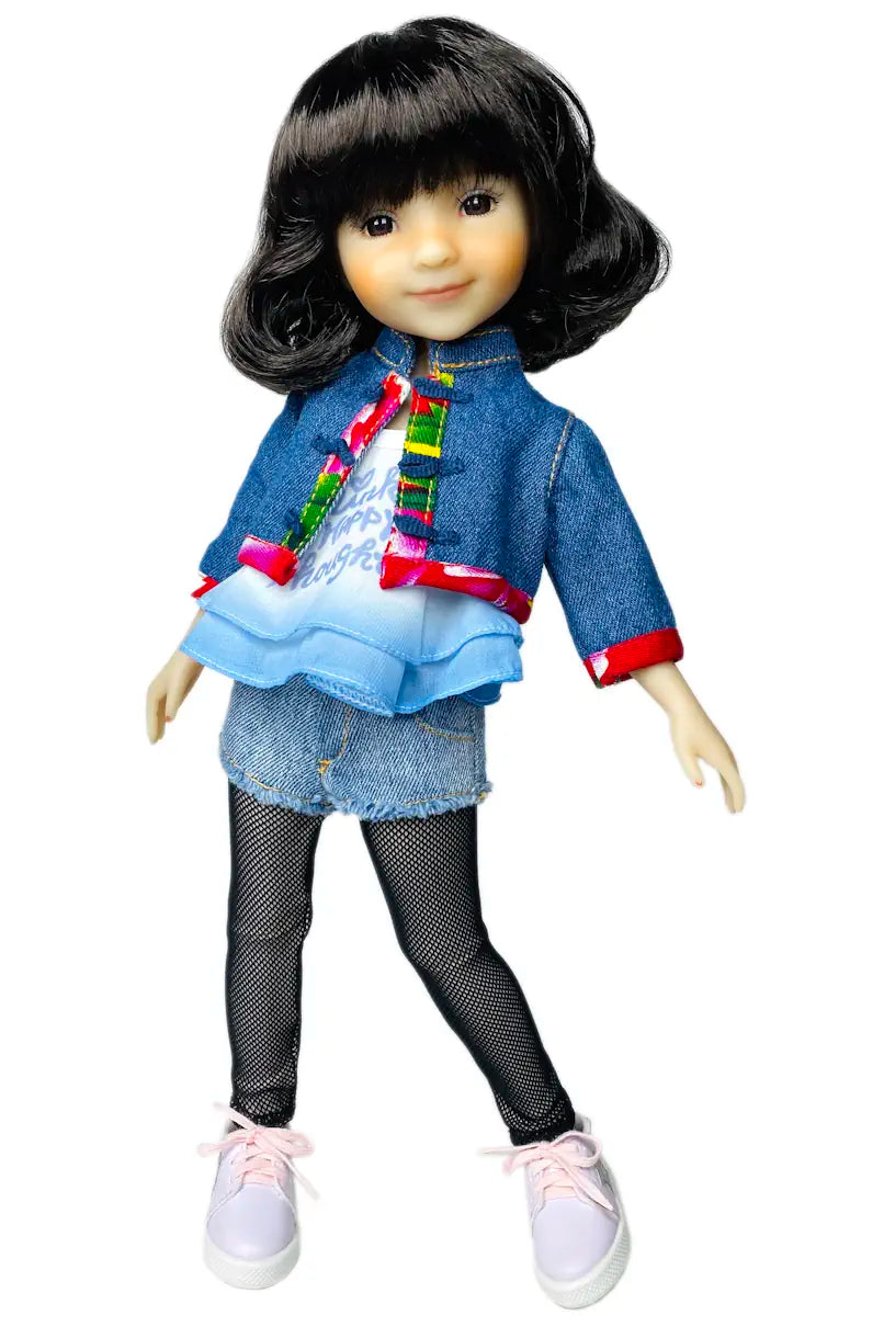 Hanna wearing a colorful outfit with a denim jacket and pink shoes on a white background