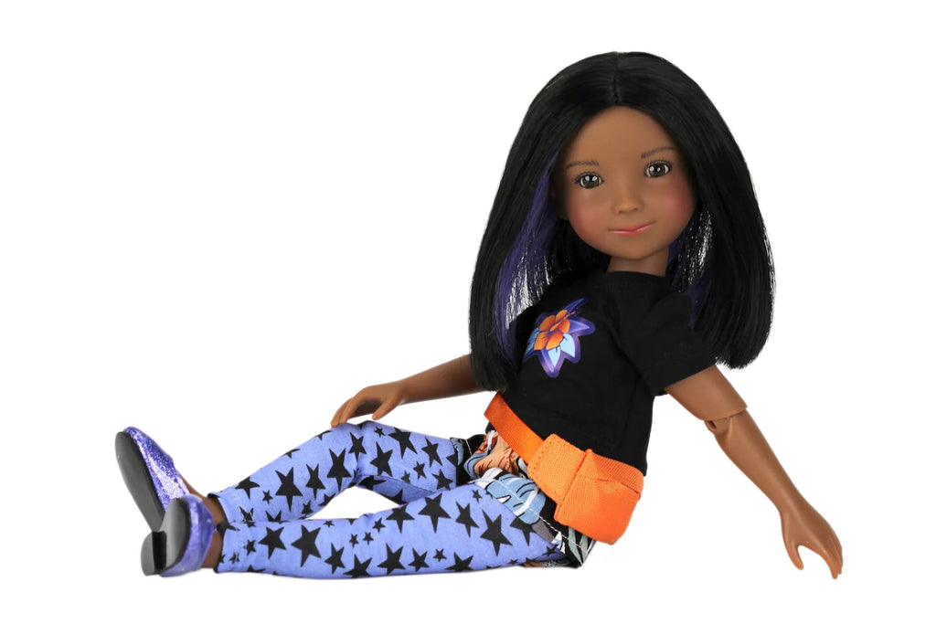 Kelsey wearing a black shirt with a colorful design, blue pants with star pattern, and orange belt on a white background