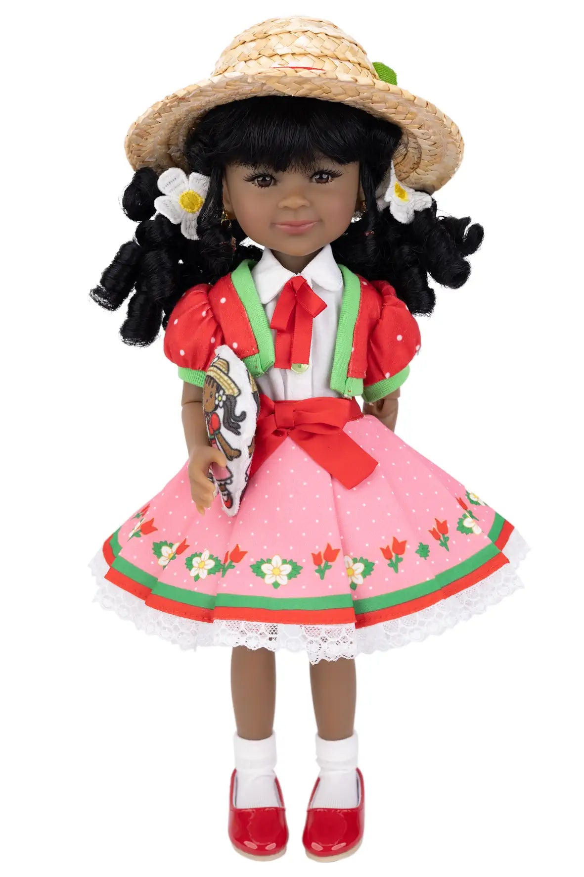 Kyra in traditional outfit with pink dress and straw hat on a white background
