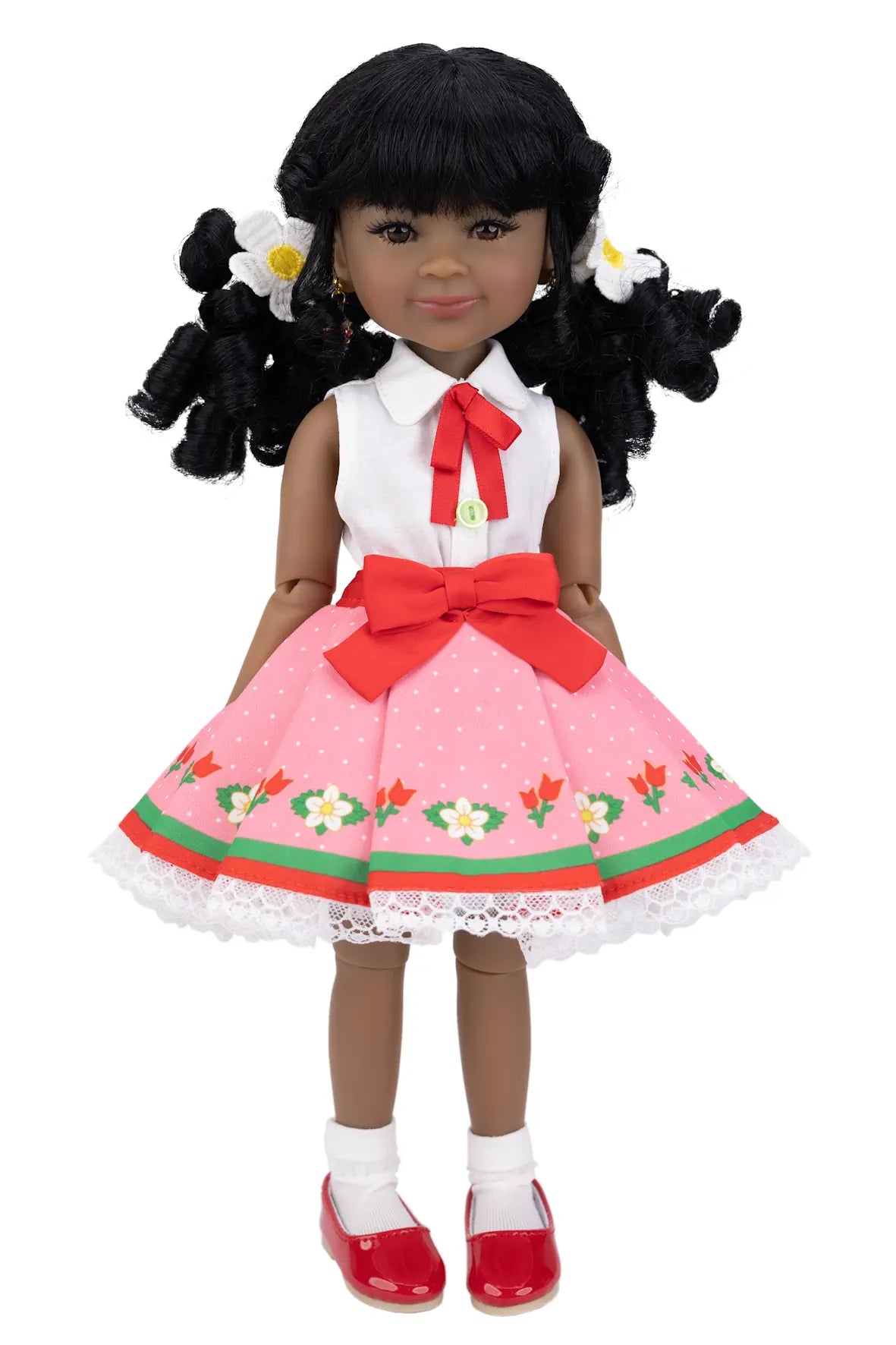 Kyra with a pink dress and red shoes on a white background