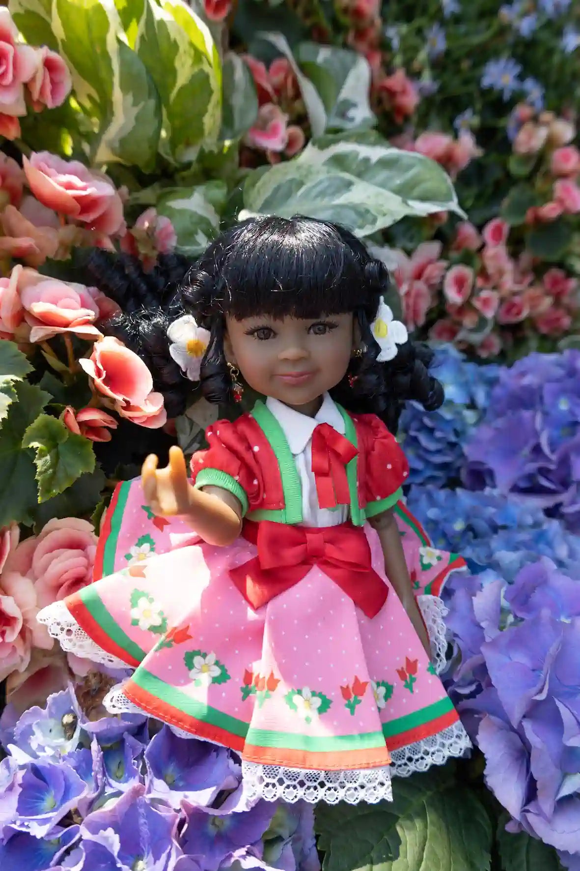 Kyra in a colorful dress surrounded by flowers