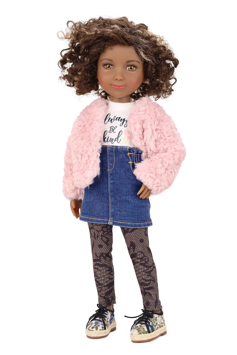 Maya wearing a pink jacket, denim skirt, and patterned leggings on a white background