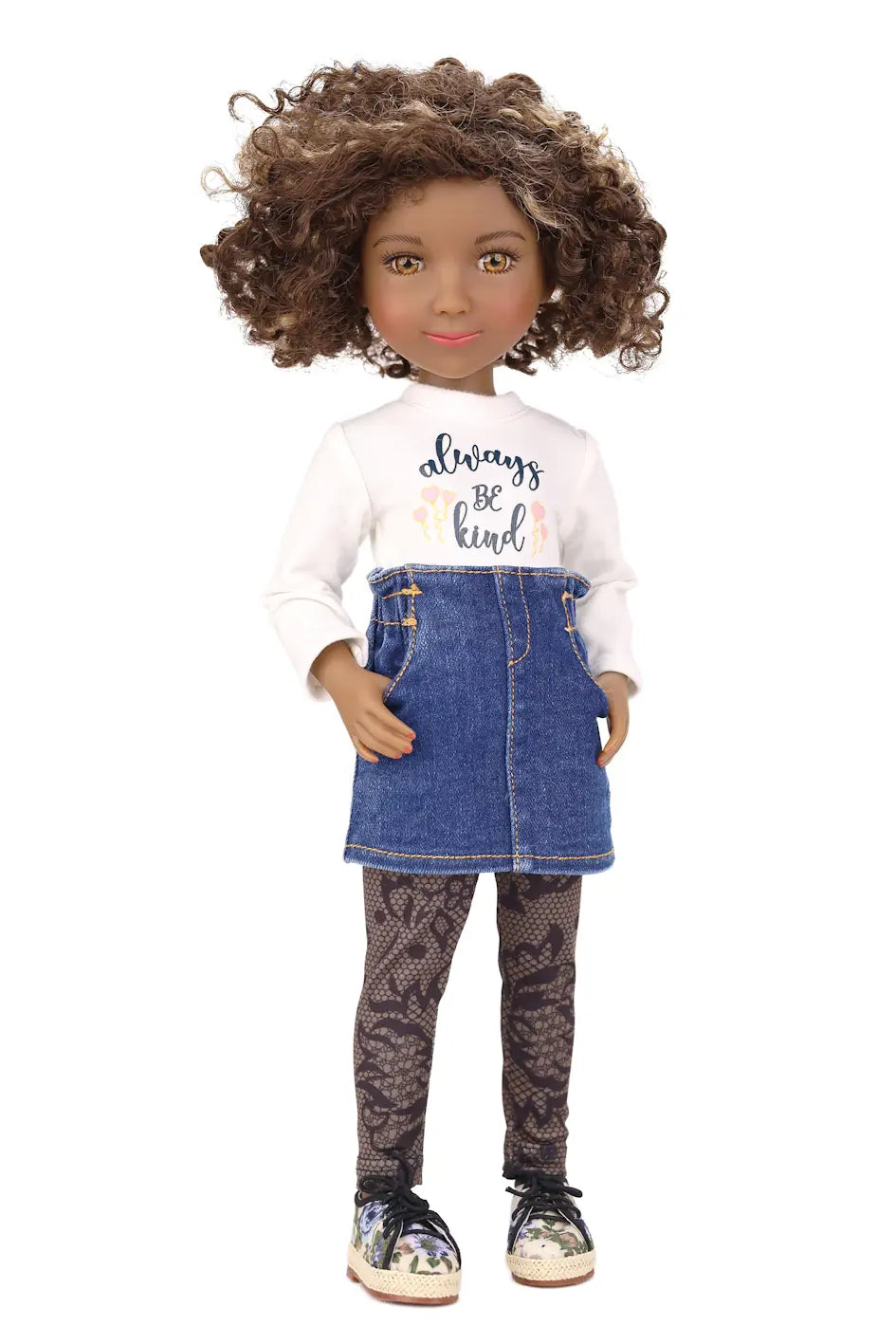 Doll wearing a white shirt with text, blue denim skirt, and patterned leggings on a white background