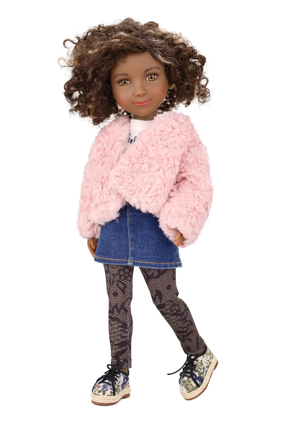 Doll wearing a pink fluffy jacket, denim skirt, and patterned leggings on a white background