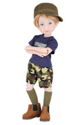 Rory wearing a blue shirt, camouflage shorts, and brown boots on a white background