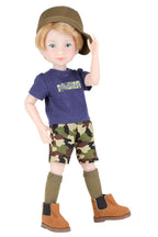 Rory wearing a blue shirt with text, camouflage shorts, brown boots, and a green cap on a white background
