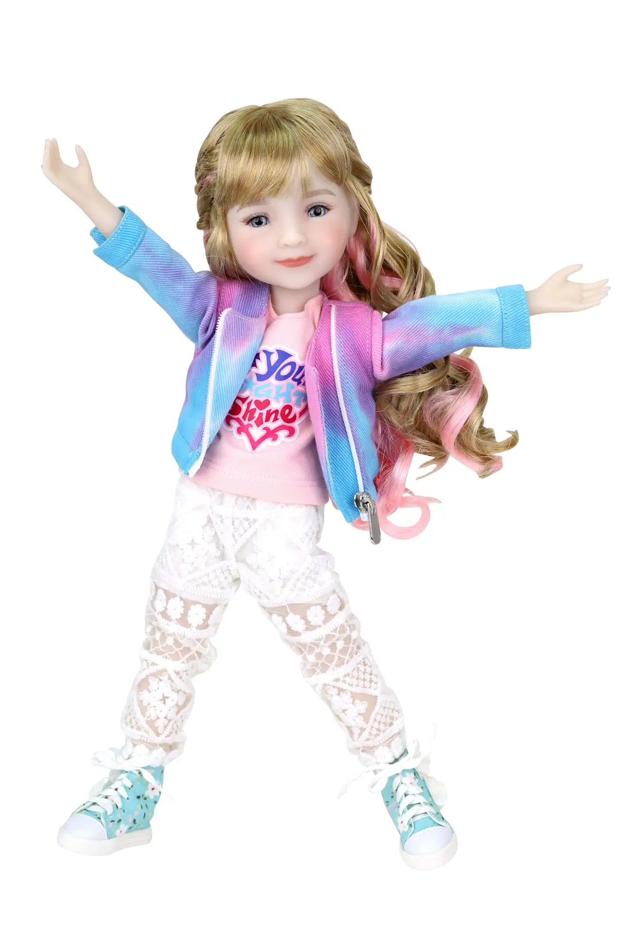 Sara, blonde hair with pink highlights, in tie-dye jacket, pink T-shirt, lace pants, arms raised, white background.