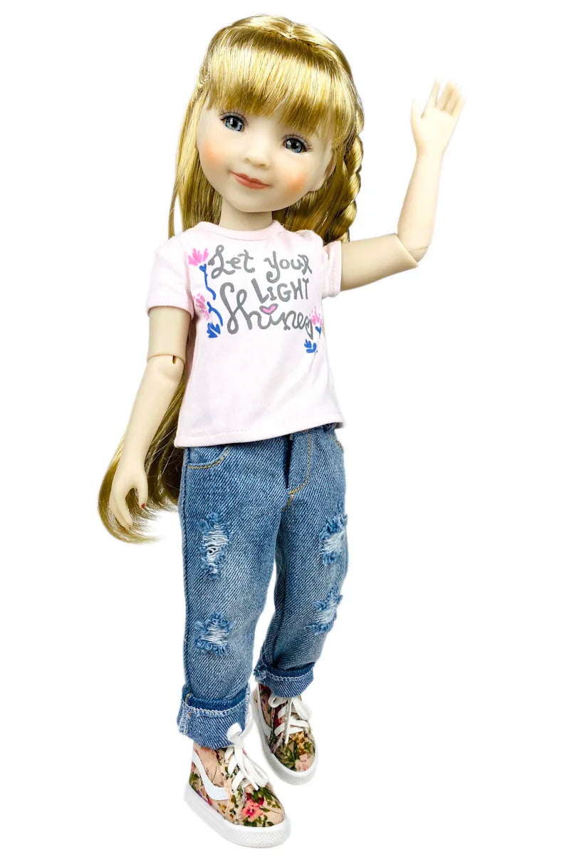 Sara wearing a white t-shirt with text and blue jeans on a white background
