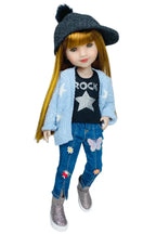 Stella wearing a blue cardigan, black t-shirt with 'ROCK' and star design, blue jeans with floral and butterfly patches, and gray shoes on a white background.