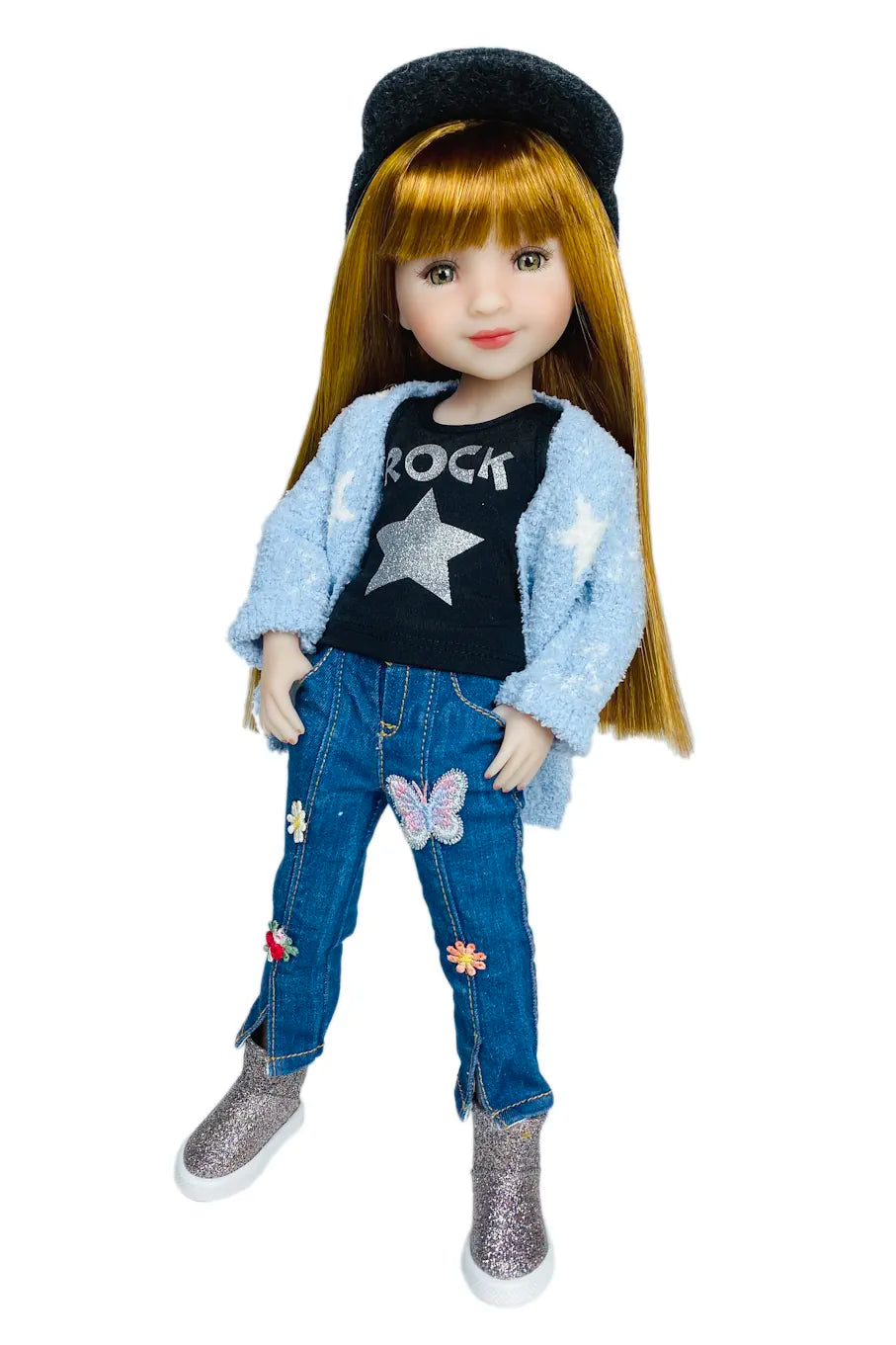 Stella wearing a black t-shirt, blue jeans with patches, and a black beanie on a white background