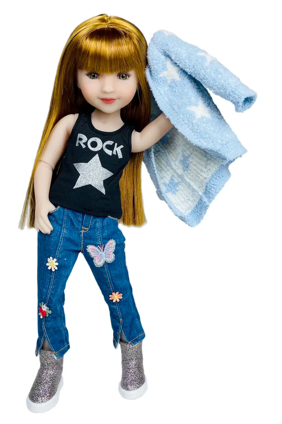 Stella wearing a black tank top, blue jeans with patches, and holding a blue jacket on a white background