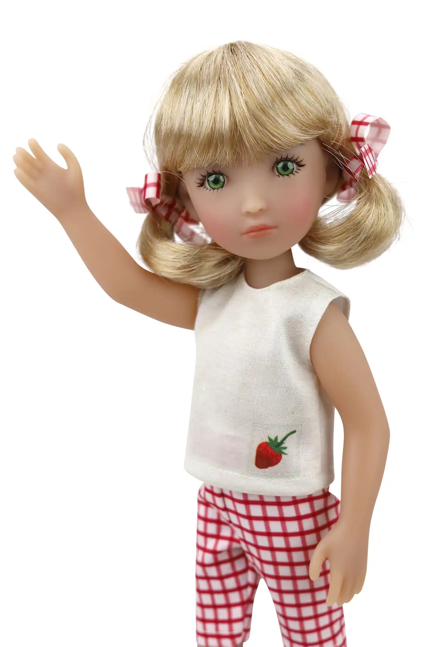 Summer, a doll with light blonde pigtails secured with red and white checkered ribbons, wears a white sleeveless top with a strawberry embroidery on the left chest and matching checkered pants, waving with her right arm against a plain white background.